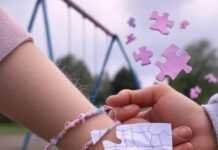 Emotional Milestones: Nurturing Your Child’s Social Development Kid with fraying bracelet, parent holding crumpled drawing, swing set, floating puzzle pieces, pastel and neon tones.