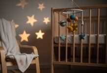 5 Proven Baby Sleep Training Methods Every Parent Should Know A blurry shot of a nursery with a crib, rocking chair, and dinosaur socks.