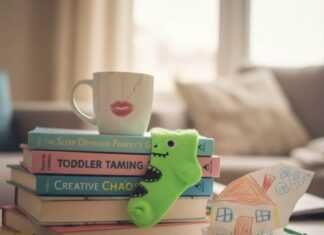 The Best Parenting Books to Read This Year Chaotic coffee table with parenting books and a dinosaur sock.